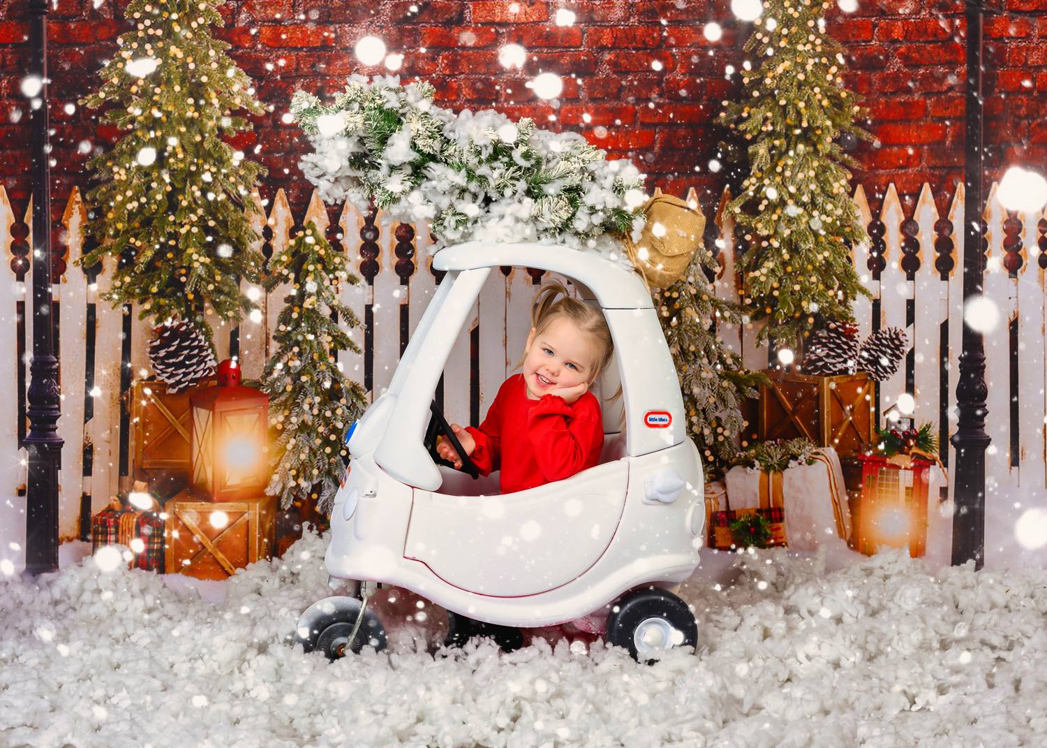 Little girl in a Christmas car at a festive photography studio in Glasgow